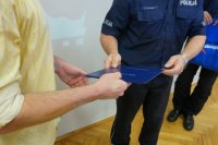 Komendant wręczający podziękowanie bohaterowi