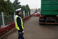 Policjant drogówki podczas przeprowadzenia kontroli pojazdu transportującego odpady