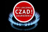 Na zdjęciu gazowy palnik a nad nim czerwone koło wewnątrz którego widnieje napis nie lekceważ zagrożenia czad!