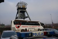 autobus Regionalnego Centrum Krwiodawstwa i Krwiolecznictwa w Katowicach na tle Wież KWK Polska. Na pierwszym planie napis policja na sygnałach świetlnych radiowozu
