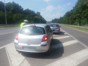 policjant z drogówki w trakcie kontroli pojazdu zatrzymanego podczas dzialań &quot;Bezpieczna DTŚ - Trzymaj się prawego pasa&quot;