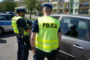 Na zdjęciu mundurowi z drogówki w trakcie kontroli zatrzymanego pojazdu, w związku z popełnionym wykroczeniem