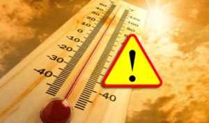Na zdjęciu termometr z wysoką temperaturą oraz znak informujący z wykrzyknikiem