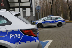 dwa radiowozy zaparkowane pod budynkiem komendy miejskiej policji w świętochłowicach