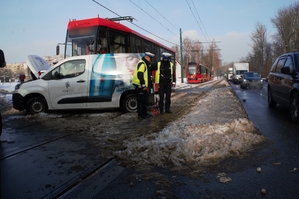 Zdjęcie przedstawia policjantów wykonujących czynności na miejscu zdarzenia drogowego