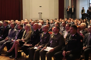 zdjęcie przedstawia siedzących na sali policjantów i gości