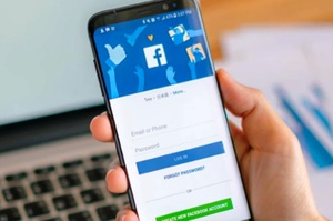 grafika przedstawia telefon z logo facebooka