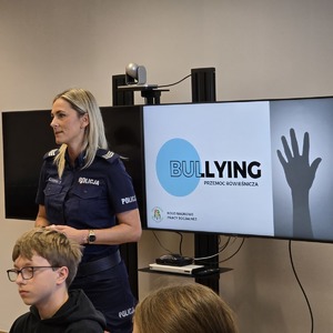 zdjęcie przedstawia policjantkę rozmawiającą z młodzieżą