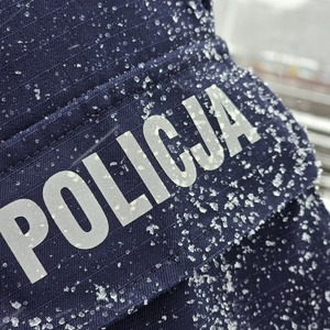 zdjęcie przedstawia napis na mundurze "Policja"